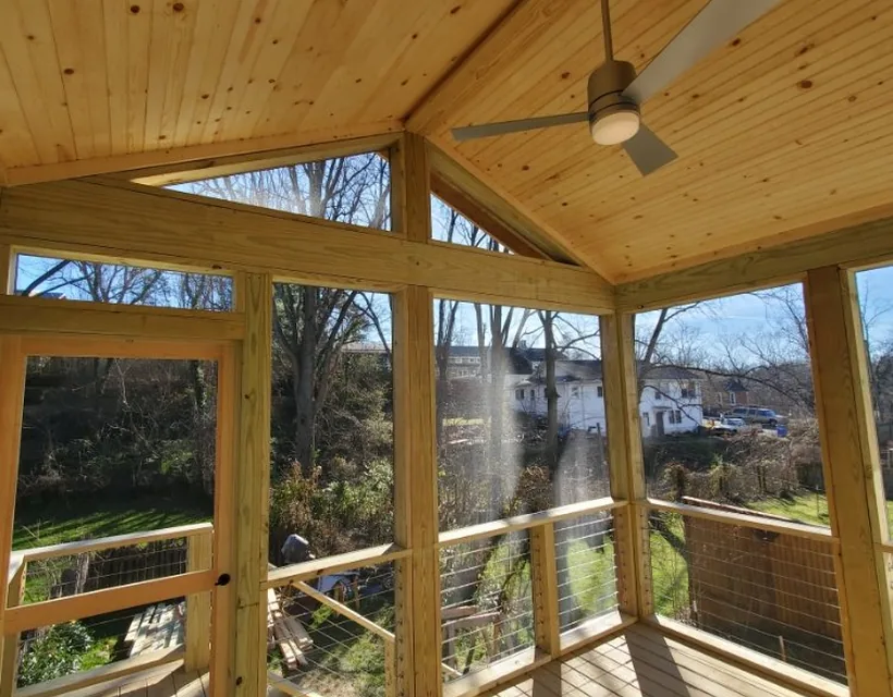 Finished screened porch interior with a tongue and groove ceiling and fan