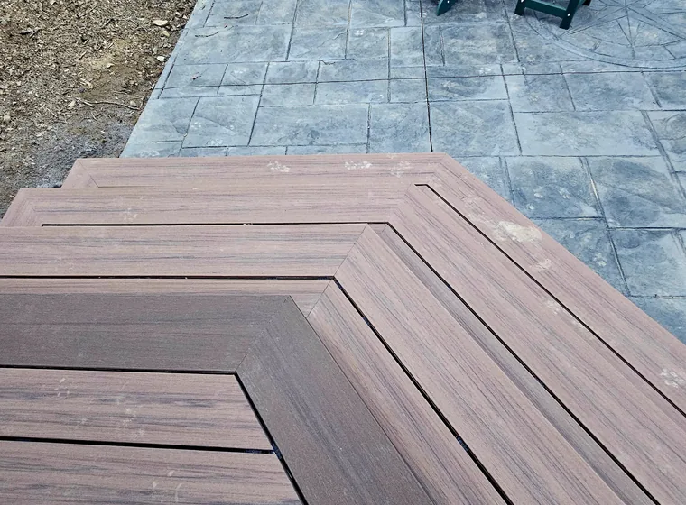 Mitred composite deck boards meeting at a clean corner