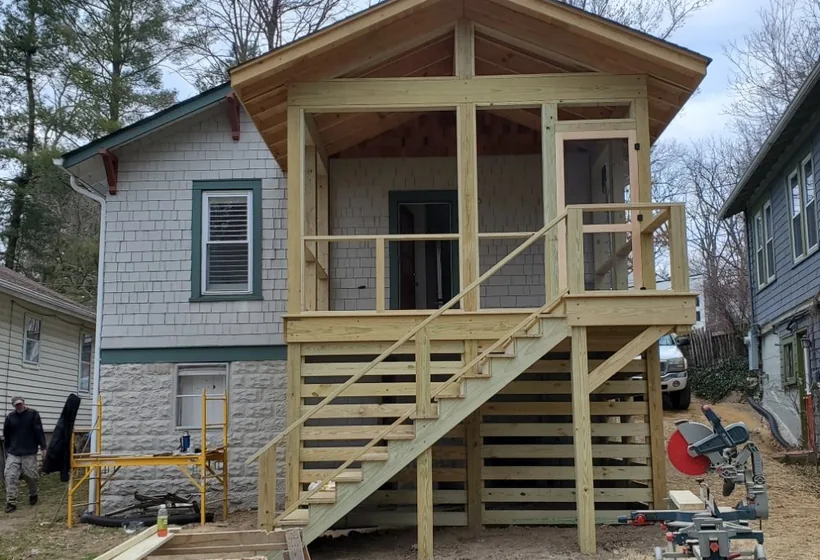 Screened porch under construction on posts, with new stairs