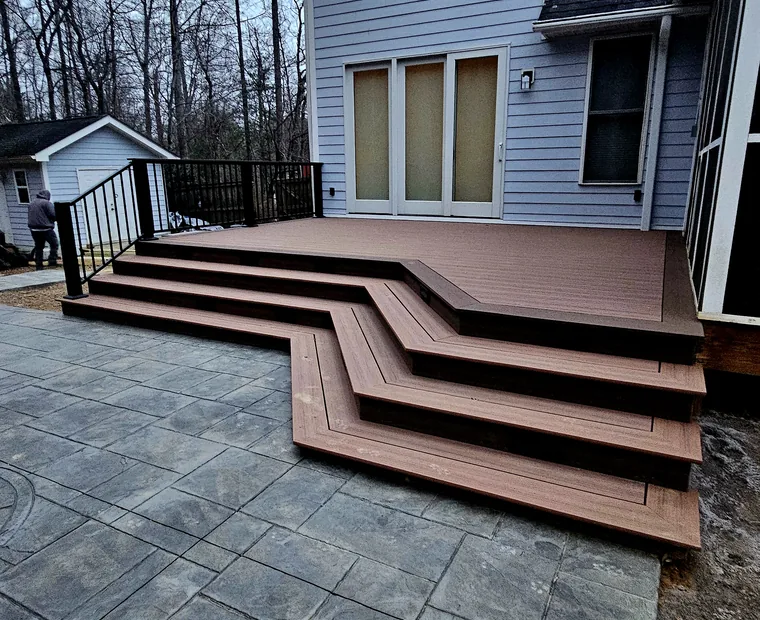Composite deck with cascading corner stairs and recessed step lighting